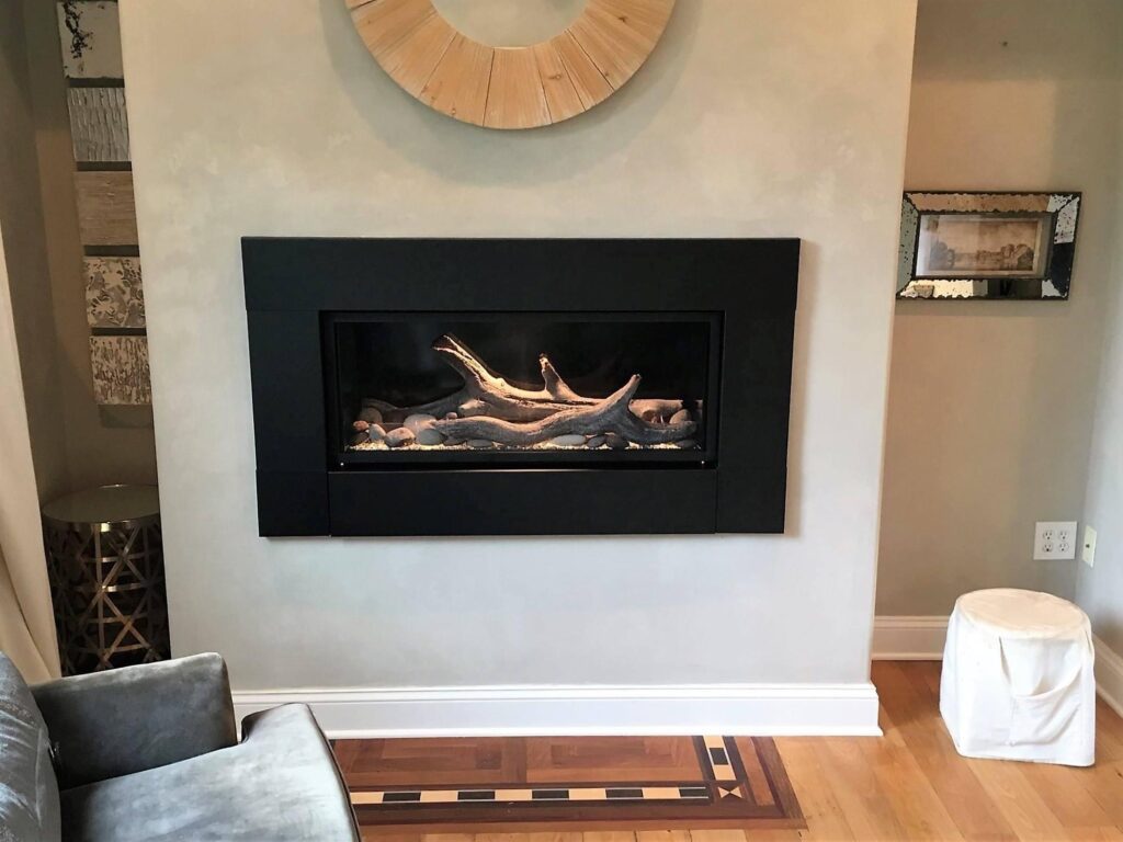 Modern fireplace with woods and rocks