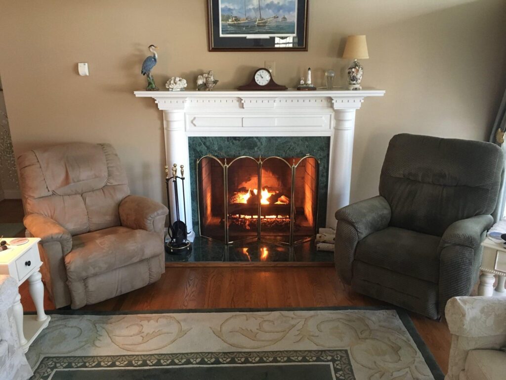 A couch beside a fireplace